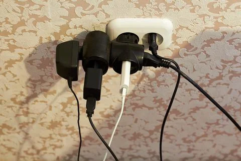 Overloaded socket, Danger of electric shock, fire. Wire, plug, fire. Stock Photos
