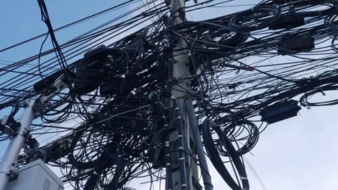 Overloaded utility pole with electrical wiring and communication lines. Stock Footage 319522870