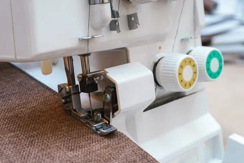 Overlock sewing machine in process. Professional equipment. Stock Photos