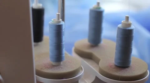 Overlock work. unwinding thread. skeins of thread closeup 库存影片 67229638