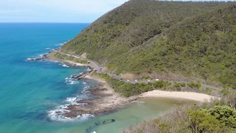 Overlook view of Great Ocean Road winding along coastline at mountain foot. Stock Footage 337981316