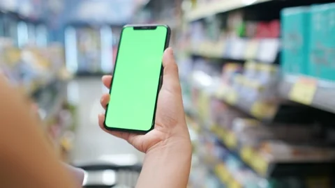 Overlooking the green screen of the phone in front of the shelf Stock Footage 207353866