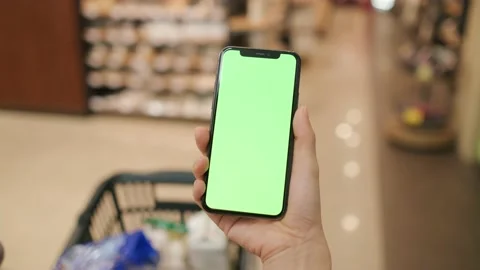 Overlooking the green screen of the phone in front of the shelf Stock Footage 207353868