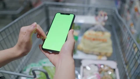 Overlooking the green screen of the phone in front of the shelf Stock Footage 208431657