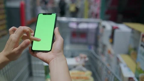 Overlooking the green screen of the phone in front of the shelf Stock Footage 208431661