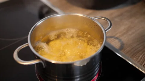 Overlooking potatoes which are cooked heavily in a small pot Stock Footage 231934133