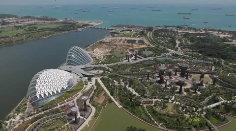 Overlooking view of Gardens by the Bay with cargo boats in background Stock Footage 50027267