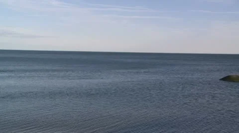 Overlooking the water with rocks on the coast Stock Footage 10775137