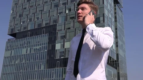 Overly joyful happy winner business man outside cell phone talking ecstatic view Stock Footage