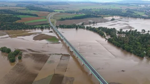 Overpass cutting through flooded fields in a drone shot. Cars drive above t.. Stock Footage 284871637