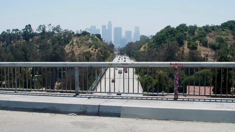On overpass overlooking freeway and downtown los angeles skyline 스톡 동영상 112756348