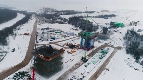 Overpass supports with metal frames and cranes in winter Video stock 237429103
