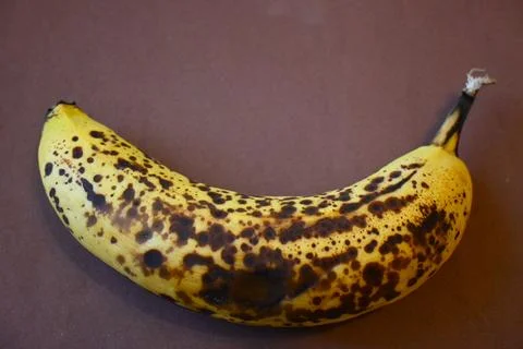 Overripe banana on brown background, copy space Photos