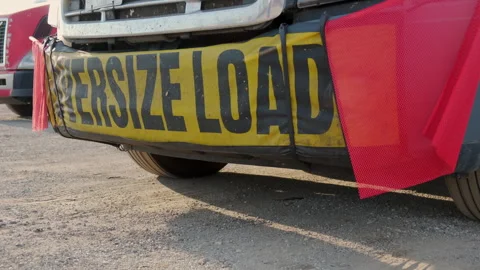 Oversize load banner and red flag on flatbed trailer. Close up Stock Footage 242707366