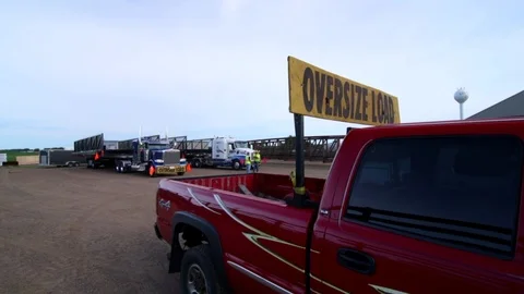 An oversized load and it's escort prepare to pull out. Stock Footage 93713790