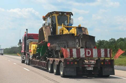Oversized Load Tractor Being Transported on Flatbed Trailer Stock-Fotos