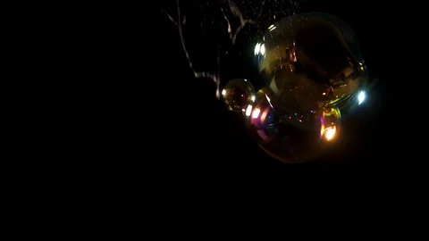 Oversized soap bubbles on right of frame with last one popping Stock Footage 77134450