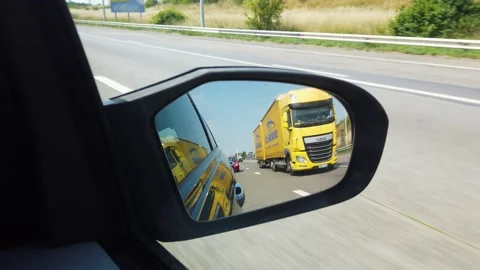 Overtaking a big truck in the reflection of side view mirror 4k Stock Footage 134908918