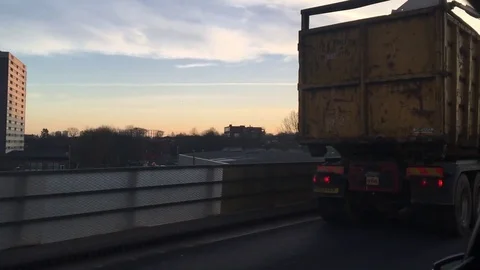 Overtaking a slow lorry on the motorway, blocking the setting sun. Stock-Footage 72627626