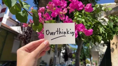 Overthinking - text with pink flowers on background, psychology issues concept 库存影片 339032129