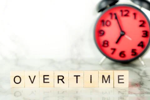 Overtime clock with text on marble copy space Фото