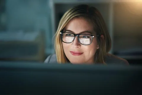 Overtime is no problem for her. a young businesswoman working late on a computer Stock Photos