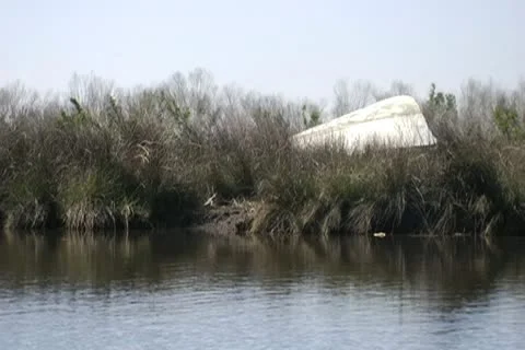 Overturned, abandoned and destroyed small boat from hurricane katrina Stock Footage 10765041