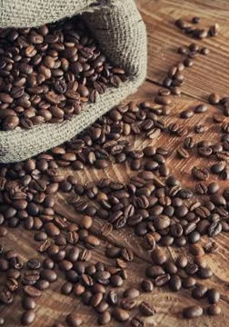 Overturned bag of coffee beans Stock Photos