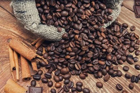 Overturned bag of coffee beans Stock Photos