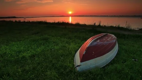 Overturned boat on grassy riverside Stock Footage 74092164