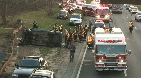 Overturned Car Accident Scene on Highway with Fire Trucks and Police Stock Footage