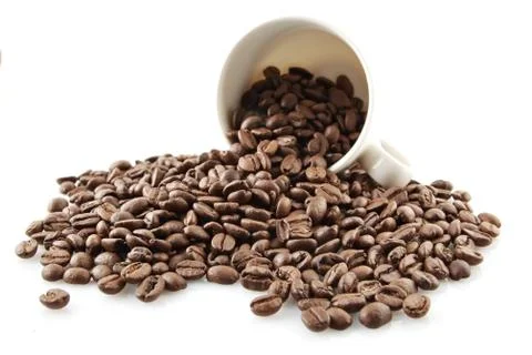 Overturned cup full of coffee beans isolated on white Stock Photos