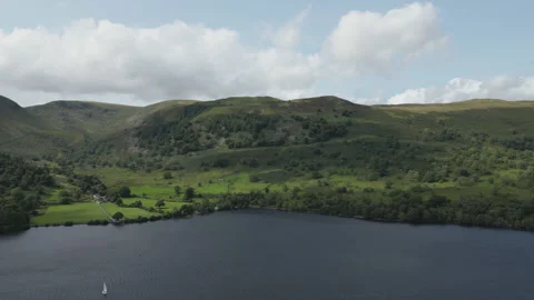 An overview of a beautiful scenery with green hill and a lake. Stock Footage 248625317