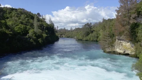 Overview bright blue Waikato river, wild water flowing down the Huka falls NZ Stock Footage 80982804