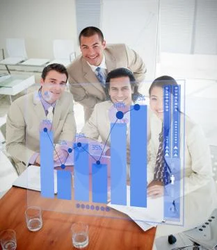 Overview of cheerful colleagues using blue chart interface Stock Photos