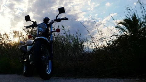 Overview of a classic motorcycle, sunset in the background Video stock 139540924