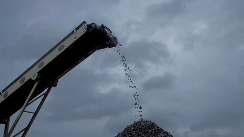 An overview of coal chunks falling from the belt conveyor at the coal mine Stock-Footage 101504395