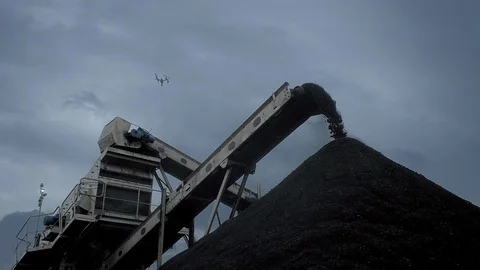 An overview of a coal falling from the belt conveyor at the coal mine Stock Footage 101502162
