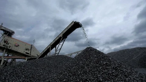 An overview of a coal falling from the belt conveyor at the coal mine Stock Footage 101503723