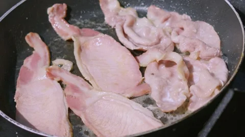 Overview of Delicious Sizzling Bacon in Frying Pan Being Cooked Outside. Stock Footage 341663844