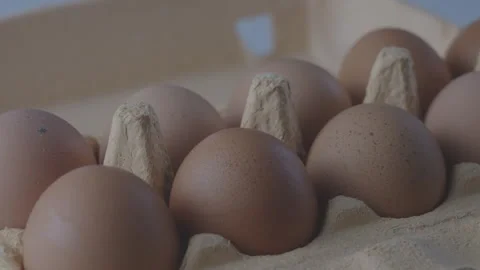 Overview of eggs in cardboard packaging standing on table Stock Footage 277466532