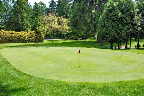 Overview of a golf field with red flags on green lawn Stock Photos