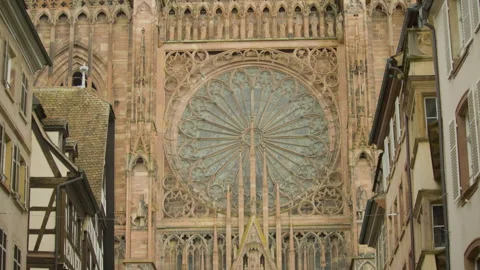 Overview of Gothic cathedral with rose window and ornate stonework. 스톡 동영상 315169611