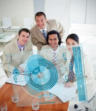 Overview of happy colleagues using blue chart interface Stock Photos