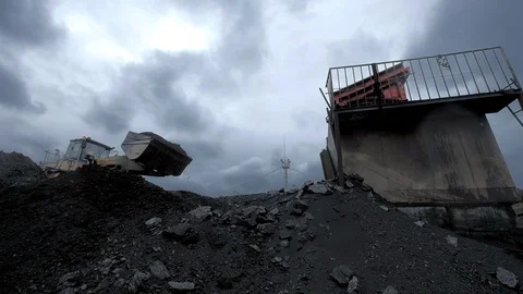 An overview of a huge excavator unloading coal into the container at the coal Video stock 101502467