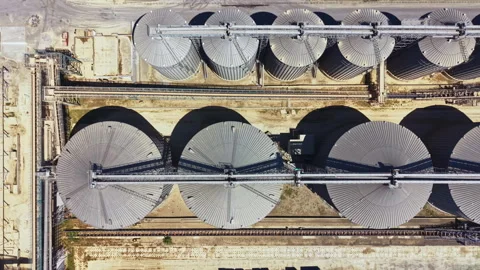 Overview of large storage silos at a grain facility along with loading equipment Video stock 337906409