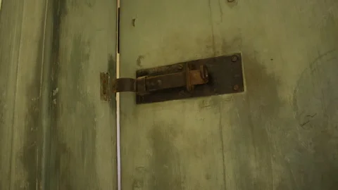 Overview on an old rusty latch on a green wooden door Stock Footage 299038950
