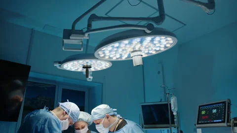 Overview of operating room with surgeons and patient in process of operation Stock Footage 239931288