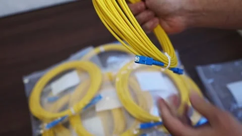 Overview Patch cord (switch cord) in the hands of a man in an engineering room Stock Footage 282983792