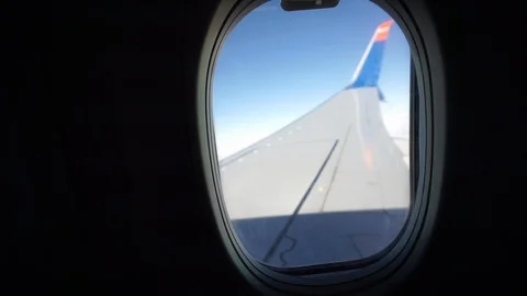 An Overview Of The Plane's Wing Above The Clouds At The Window - Wide Shot Stockbeeldmateriaal 125780301